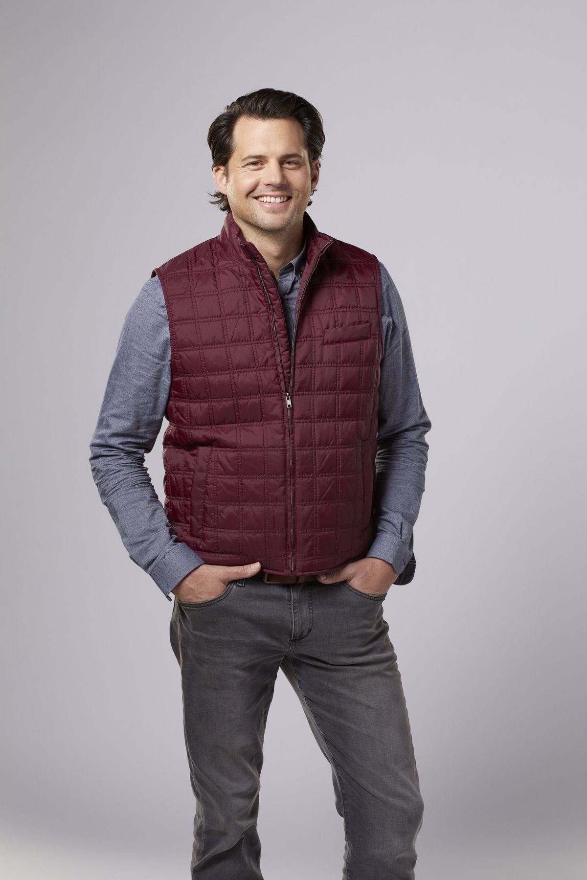 Studio portrait of Kristoffer Polaha in a burgundy waistcoat