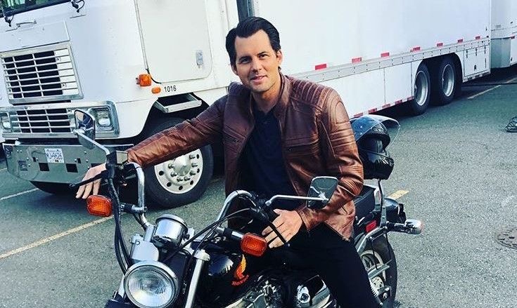 Behind the scenes: Kristoffer Polaha on a motorcycle between takes